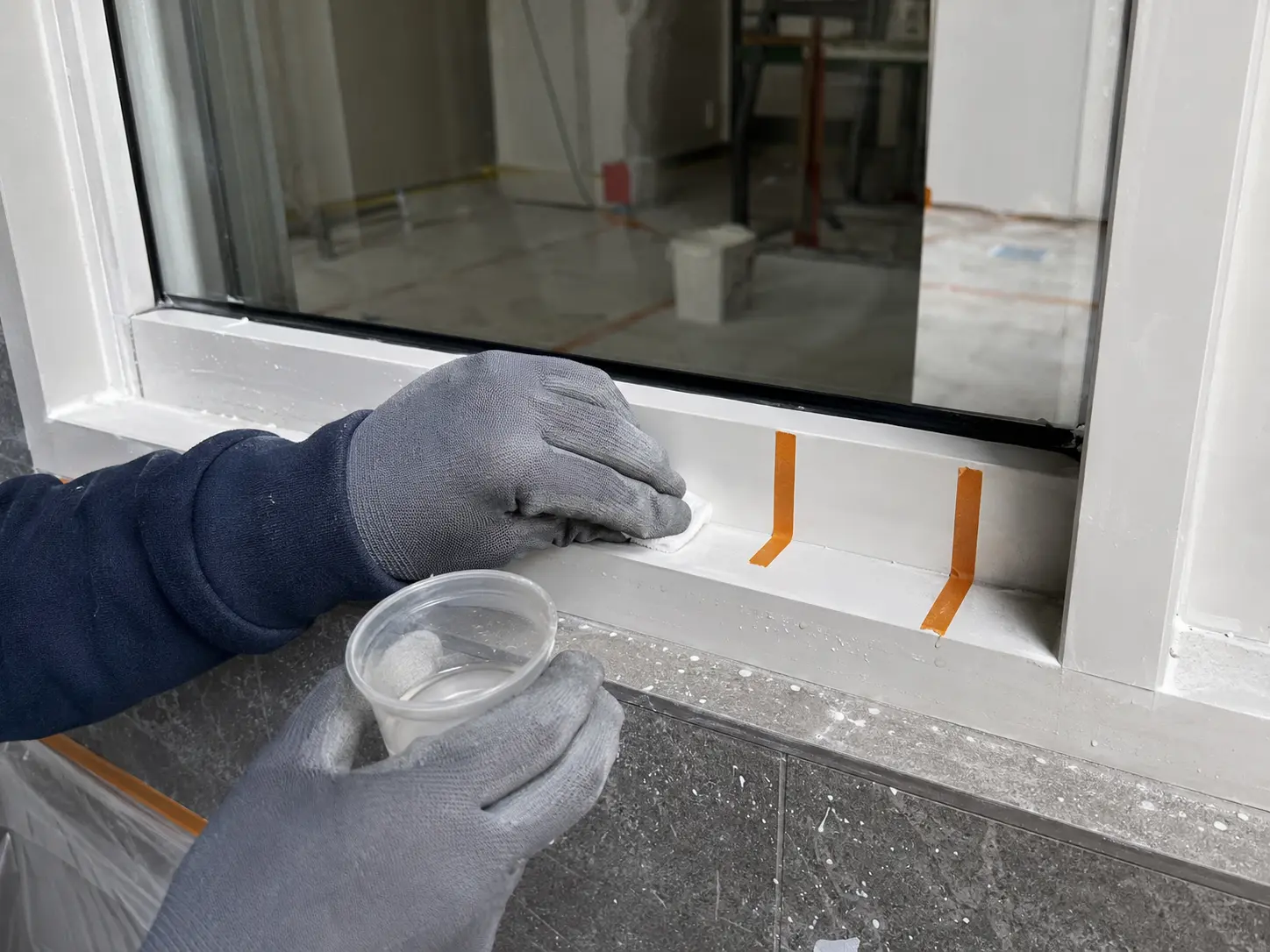 Materialbezogene Probefläche an einem neuen Bauteil während einer Baureinigung